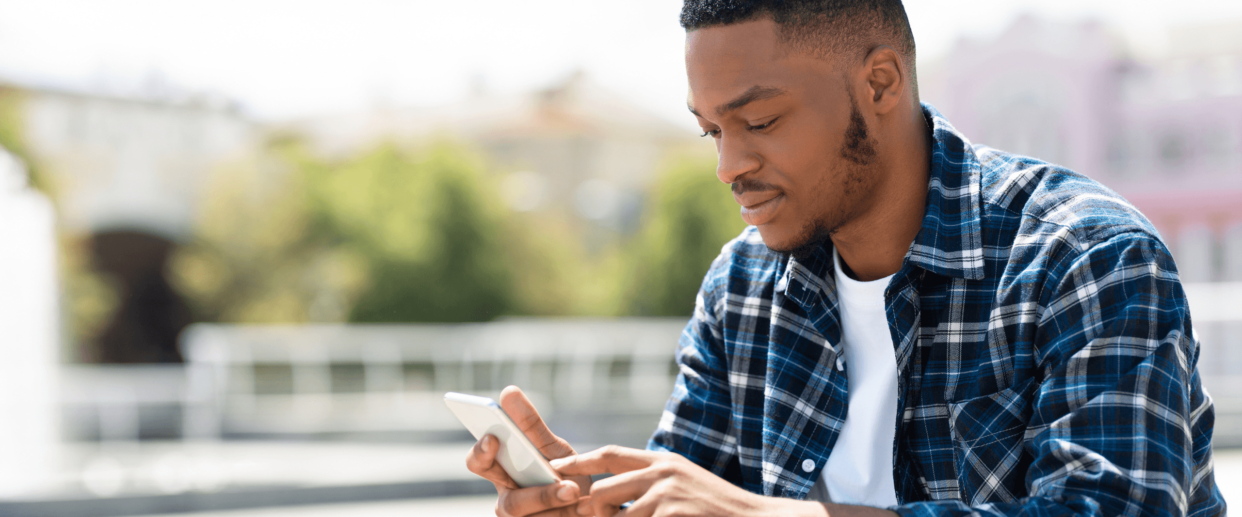 Man checking his credit report on his phone while looking up what it costs to dispute an error