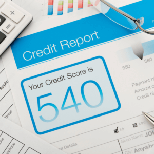 a credit report showing a 540 credit score in blue letters, calculator and reading glasses in corner